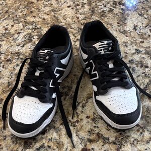 New Balance Men's Classic Black and White Sneakers